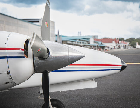 Side shot of a modern white aircraft plane on the kand with colorful lights on a sunny day