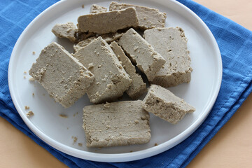 slices of sunflower halva on a white plate.