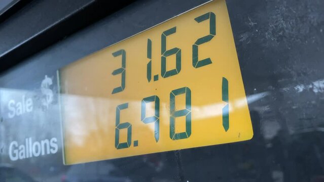 Close up on fuel prices adding up fast at gas station.