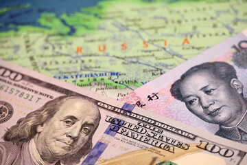 US dollar and Chinese yuan on the map of Russia. Concept of economic cooperation between the Beijing and Moscow during american sanctions due conflict in Ukraine