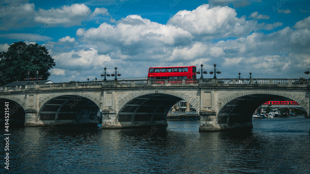 Poster view of the classic red london bus, crossing kingston upon thames bridge