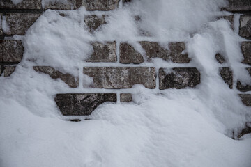 Photo of brick wall covered with snow