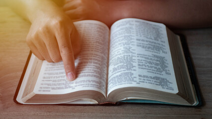 Naklejka premium Close up of a man reading the Holy Bible.
