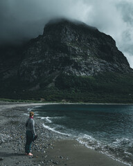 Fototapeta premium Shot of a girl discovering a natural green place and looking to mountain and sea view