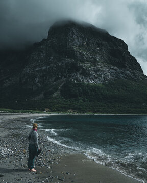 Shot of a girl discovering a natural green place and looking to mountain and sea view
