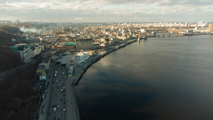 Obraz premium Scenic top panoramic view of Kyiv city Podol old center, Dnepr river Rybalskiy island panoramic landscape. Ukrainian capital Kiev blizzard panorama