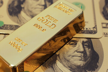 Gold bar on US dollar background. Conceptual image of gold trading, gold future, commodity trading,...