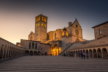 ASSISI, ITALY, 6 AUGUST 2021 Sunset over the San Francesco Basilica, one of the most important catholic churches - obrazy, fototapety, plakaty