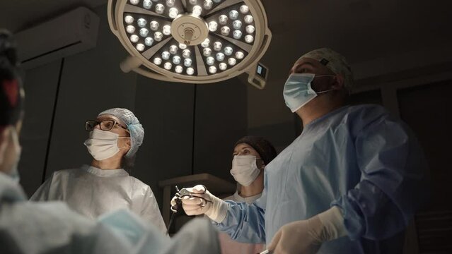 Team surgeon at work in operating room. Modern equipment in operating room. Medical devices for neurosurgery