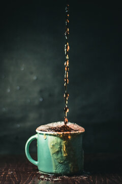 Vertical Shot Of An Overfilled Cup Of Coffee