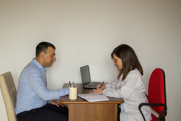 Female doctor with patient in the office while prescribing a prescription for medicines