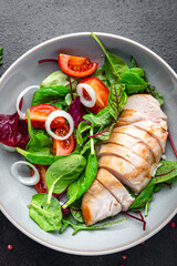 salad chicken breast vegetable tomato, onion, green mix leaves lettuce fresh meal food snack on the table copy space food background 