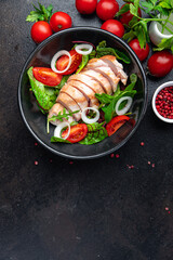 salad chicken breast vegetable tomato, onion, green mix leaves lettuce fresh meal food snack on the table copy space food background 