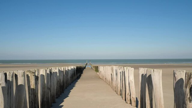 Breakwater and bollards on Domburg beach, Netherlands, tracking shot