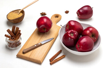 Ripe red apples in bowl. Apple and knife on cutting board.