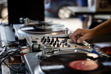 DJ on a mixer with turntables