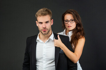 business partners on black background. formal couple in love. businessman and businesswoman