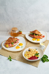 Breakfast served with tea, croissants and pancakes.
