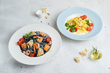 Spaghetti and penne pasta with tomatoes and basil