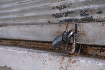 Closed shop shutter and padlock. Economic crises and bankruptcies.