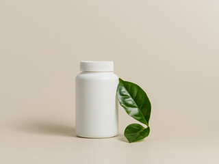 Mockup medical bottle of pills or vitamins with green leaf on beige background, organic medication,...