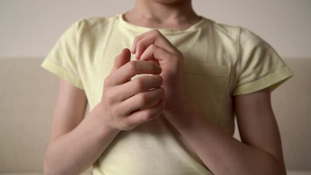 Child practicing EFT or emotional freedom technique - tapping on the side of hand, slow motion