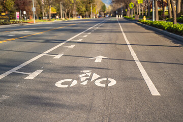 Bicycle path on a city street. A white bicycle symbol on the road. 