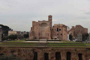 ROME, ITALY - February 05, 2022: Panoramic view of inside part of Colosseum in city of Rome, Italy. Cold and gray sky in the background. Macro photography of the arches.