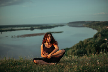 Fototapeta premium Yoga practice and meditation outdoor. Girl in the park