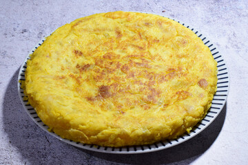 Potato omelette, typical of Spain, on a porcelain plate.