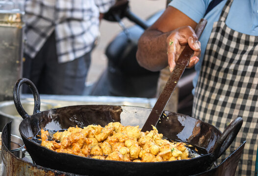 Closeup shot of a male making a Bhajji(Pakodas)