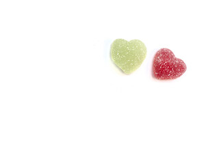 Obraz na płótnie Canvas Two sweet hearts: Candy Hearts Green and Red Jelly in Heart shape flatlay isolated on white