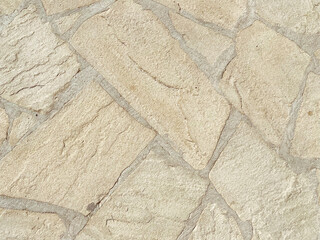 The texture of the wall is made of beautiful smooth, natural old, old, shuffled gray densely laid out without gaps, cobblestones, masonry with uneven seams. The background