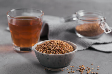 Bowl of fenugreek seeds and Egyptian fenugreek yellow tea or Methi Dana drink