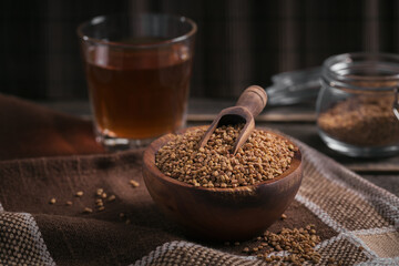 Bowl of fenugreek seeds and Egyptian fenugreek yellow tea or Methi Dana drink