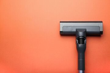 Vacuum cleaner on orange background. Top view. Cleaning concept.