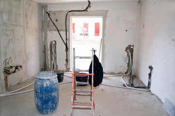 Renovation work in a house with the arrangement of electrics and plumbing before paving.