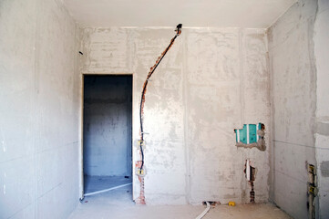 Renovation work in a house with the arrangement of electrics and plumbing before paving.