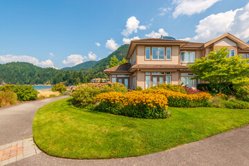 luxury house with garage door, big tree and nice spring blossom