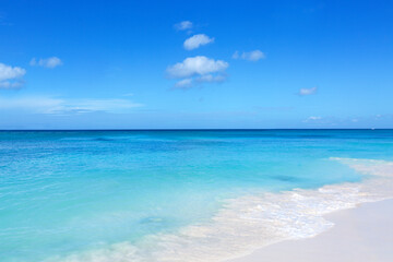 Fototapeta na wymiar Travel background with white sand beach and Caribbean sea.