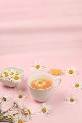 Chamomile herbal tea on a gentle pastel background, alternative medicine concept,summer background,chamomile is a medicinal plant and is used to treat diseases and calms the nerves, selective focus