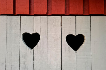 travel sweden and scandinavia, two cut outs in shape of a heart at a scandinavian hut
