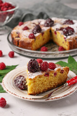 Homemade blackberry and raspberry pie, with piece on plate on light gray background