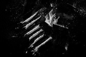 Cocaine lines isolated on black, top view  