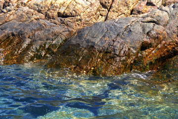Fototapeta premium View from the water to the rocky seashore in summer. ..