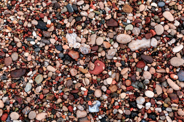 A lot of multi-colored stones of different shapes.