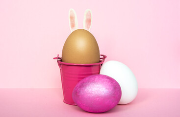 multi colors painted easter eggs in colored buckets with rabbit ears. Happy Easter Card	
