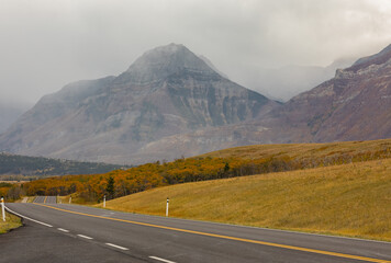 Highway through mountains landscape at overcast day. Horizontal shot