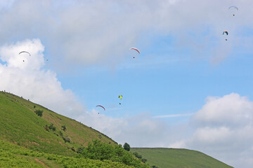 Paragliders flying above the ridge at Pandy, Wales