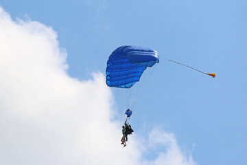 Tandem Skydiver flying wing in a blue sky